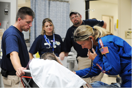 Galveston Island, Texas, September 18, 2008 - Members of the Iowa-1 Disaster Medical Assistance Team help to move a patient out of the area impacted by Hurricane Ike. (Jocelyn Augustino/FEMA)